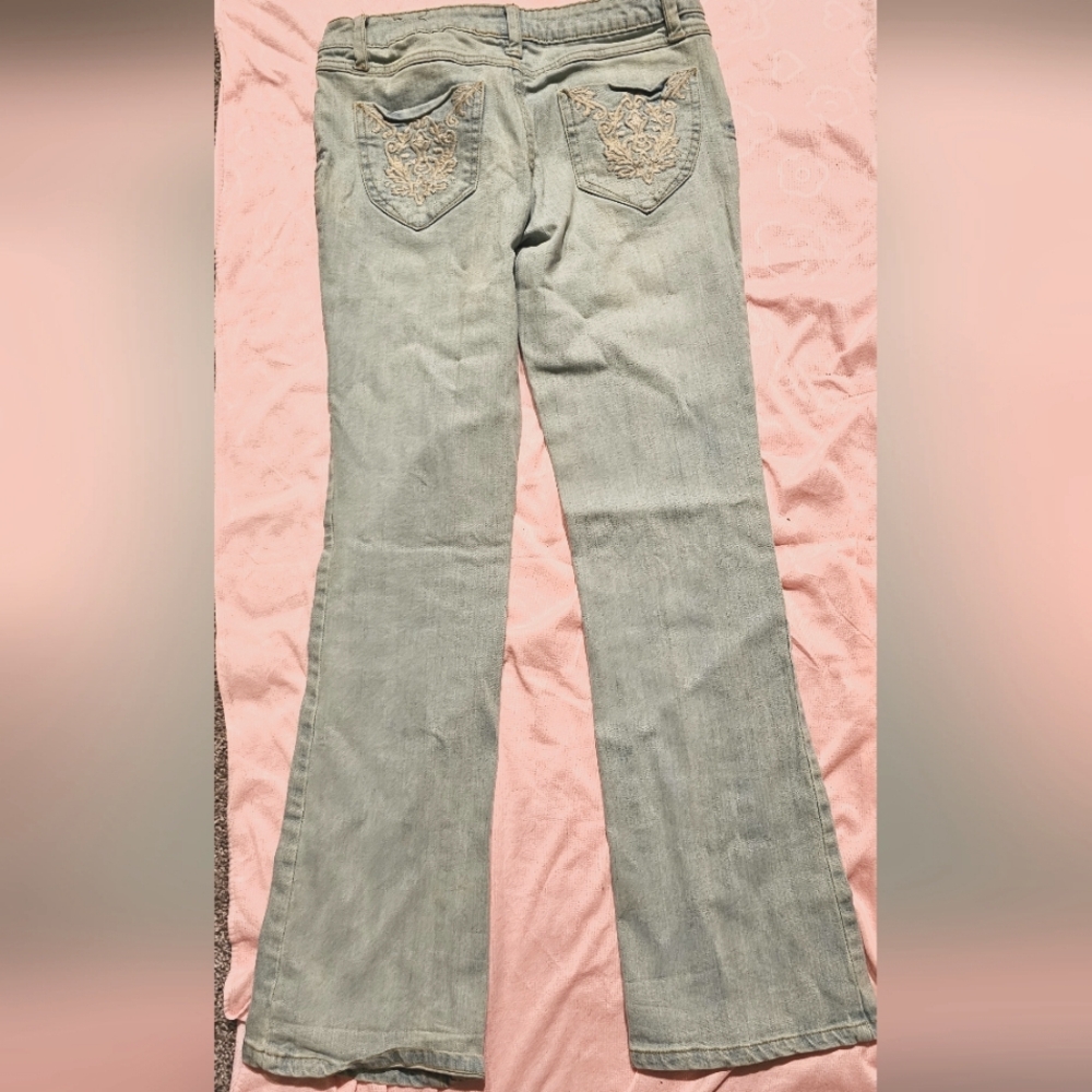 Jeans light blue with design on back pockets.  Leggs flairs
